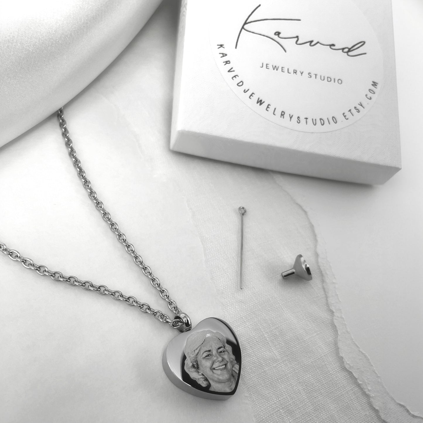 Custom photo cremation urn necklace displayed with Karved Jewelry Studio gift packaging.