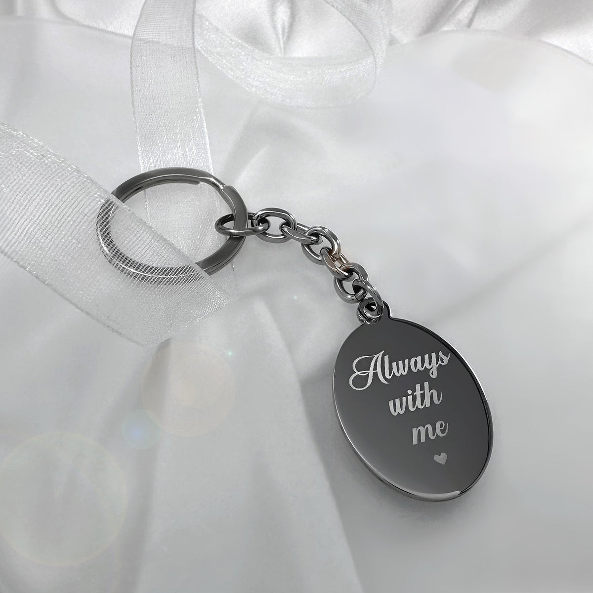 Personalized oval fingerprint keychain engraved with “Always with me” on the back