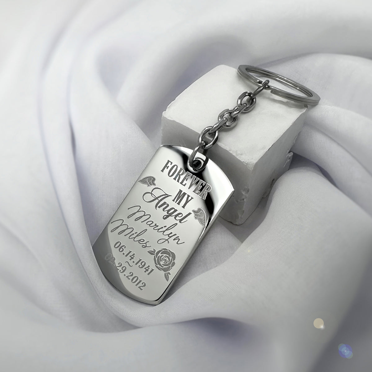 Angel memorial dog tag keychain close-up engraved with “Forever My Angel,” personalized name, rose, angel wings, and memorial dates