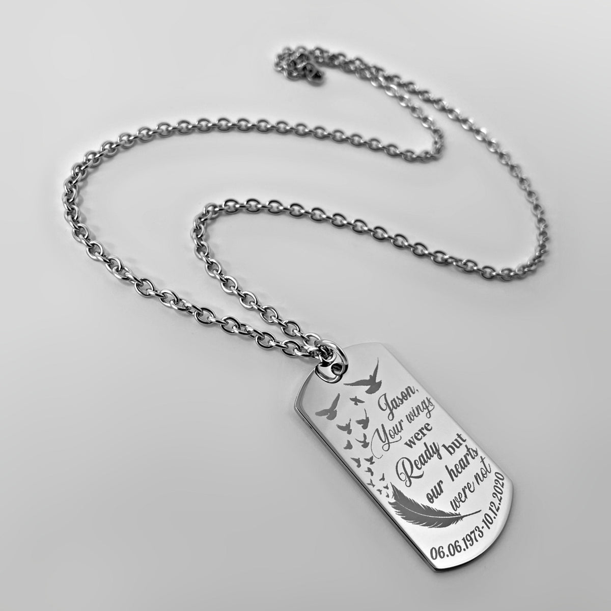 Memorial dog tag necklace close-up engraved with “Your wings were ready but our hearts were not” and bird design