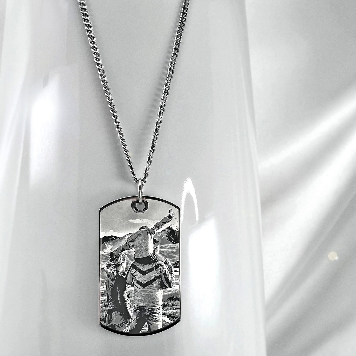 Custom photo memorial dog tag necklace displayed on satin with personalized portrait engraving