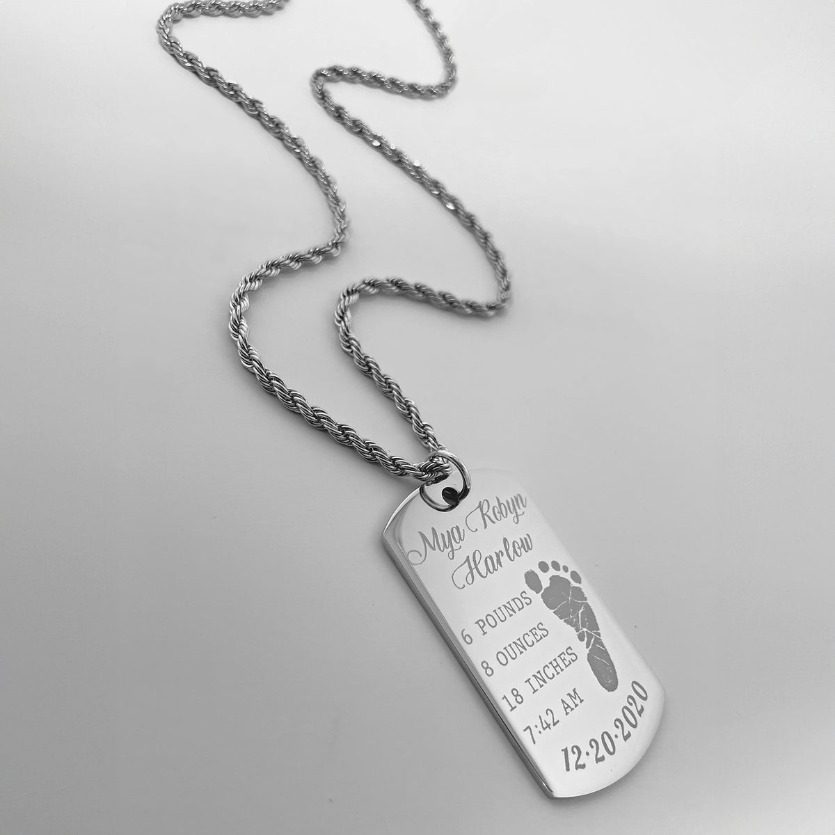 Baby keepsake dog tag necklace engraved with personalized birth details and footprint