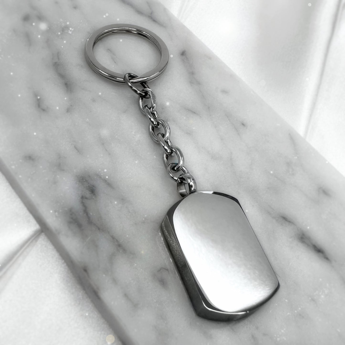 Blank stainless-steel cremation urn keychain ready for custom photo and memorial engraving.