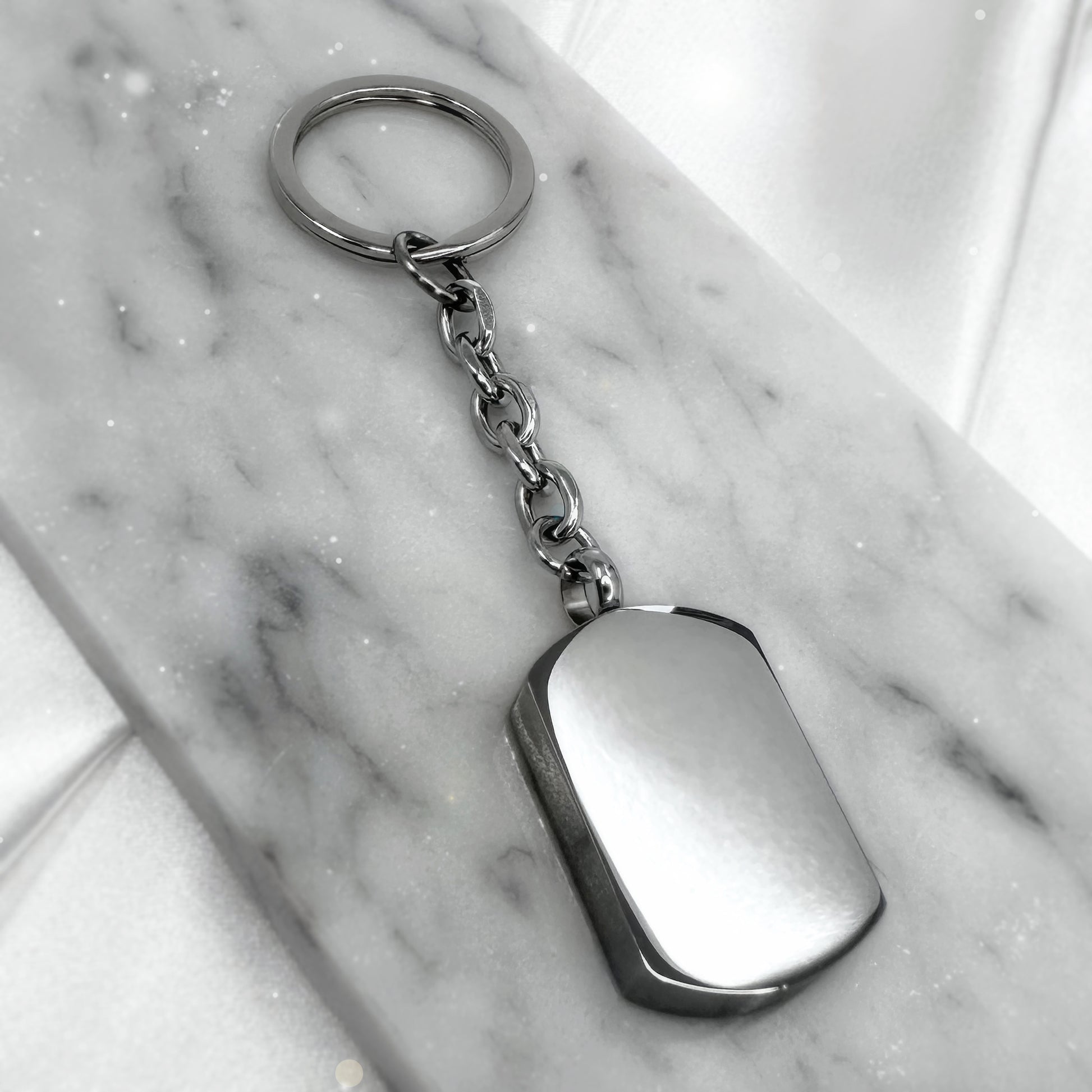 Blank stainless-steel cremation urn keychain ready for custom photo and memorial engraving.
