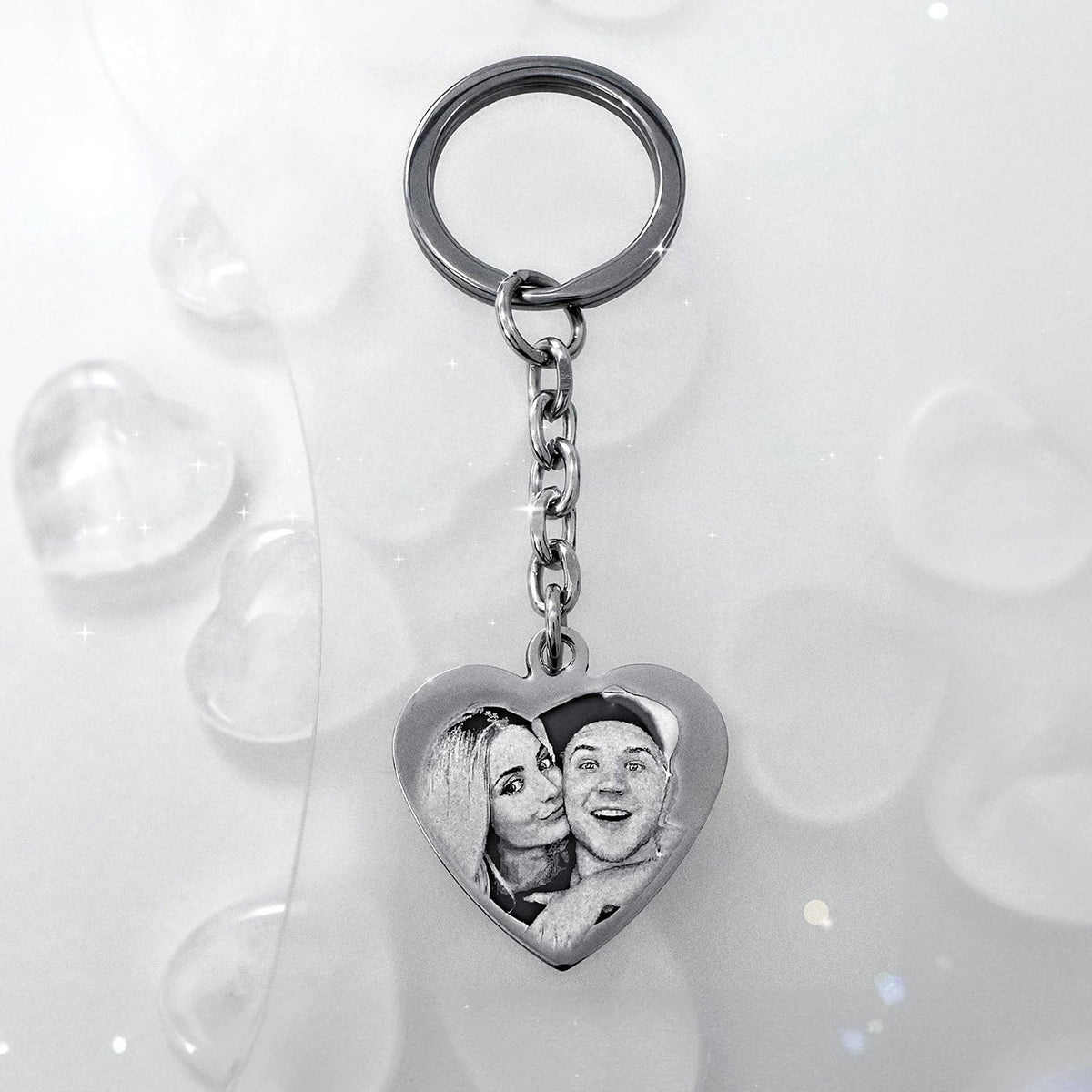 Personalized couple photo heart keychain displayed on a muted white background