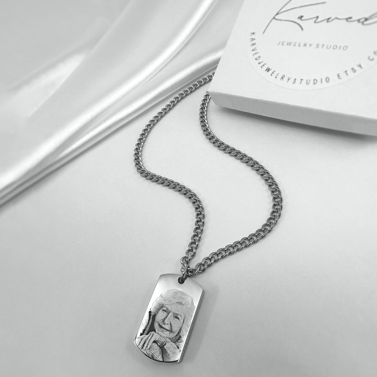 Personalized dog tag urn necklace with custom photo engraving displayed in a gift-ready box
