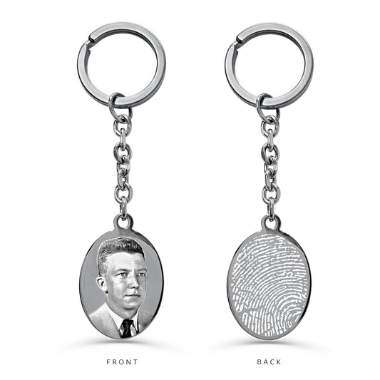 Personalized silver oval keychain with custom portrait engraving on the front and fingerprint engraving on the back