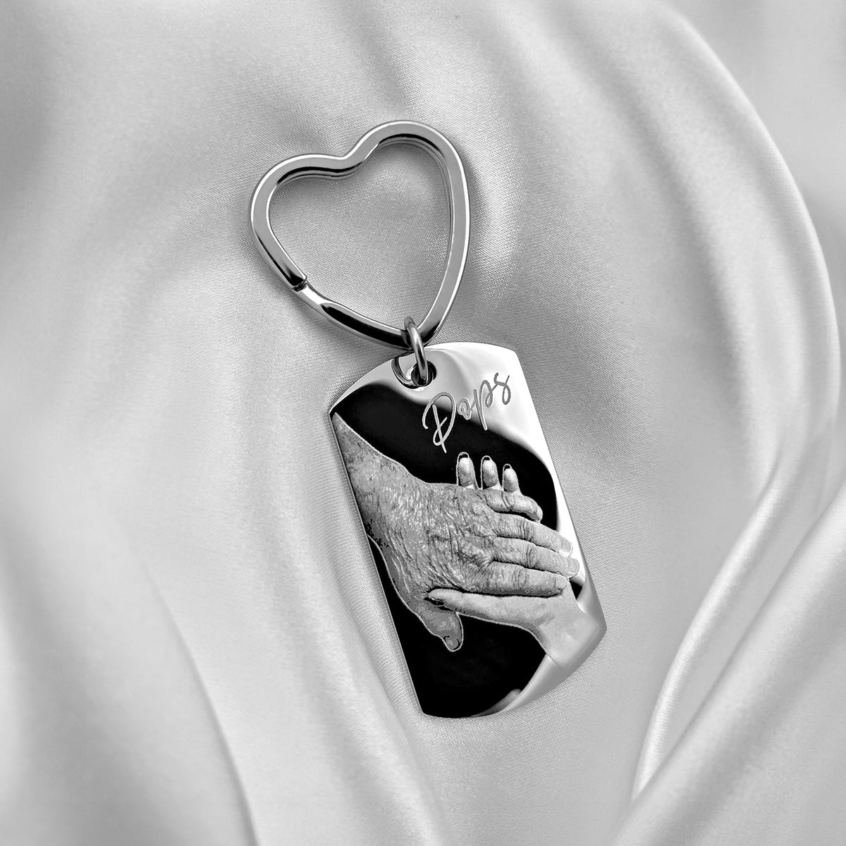 Personalized Pops handprint dog tag keychain with heart-shaped keyring displayed on soft satin