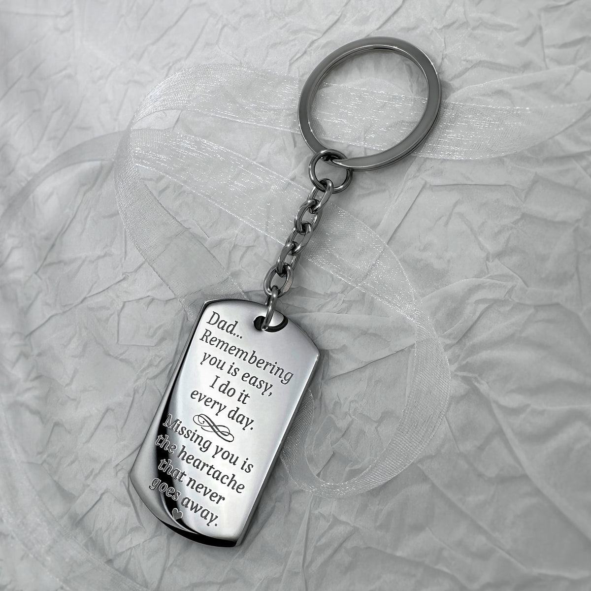 Dad memorial dog tag keychain engraved with “Remembering you is easy, missing you is the heartache that never goes away” message