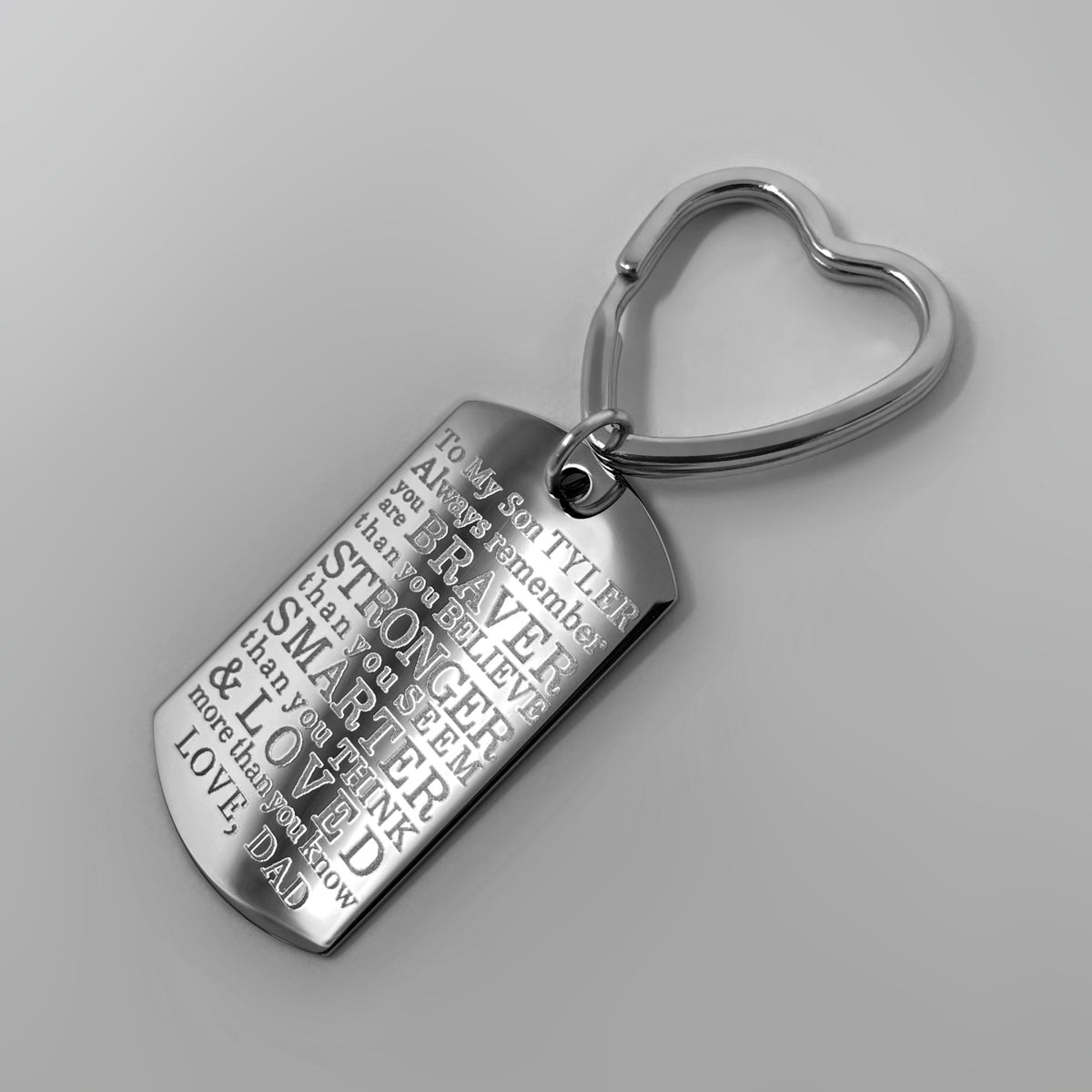 Dad to son engraved dog tag keychain close-up with personalized “Always remember you are braver than you believe, stronger than you seem” message