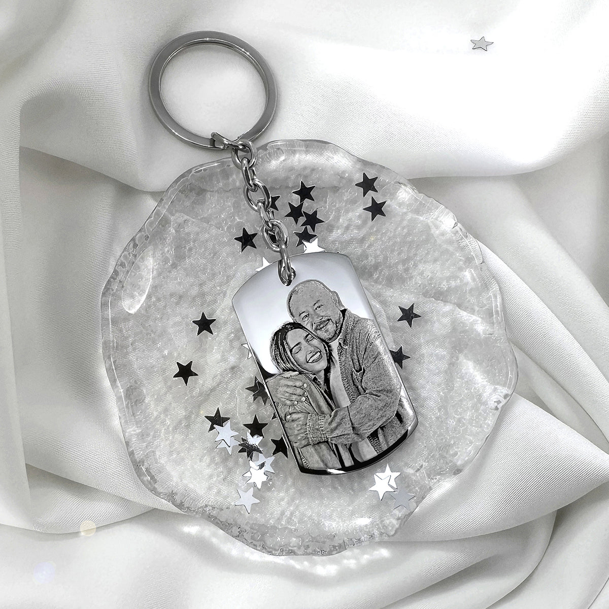 Custom father-daughter memorial dog tag keychain with portrait engraving displayed in a soft styled setting
