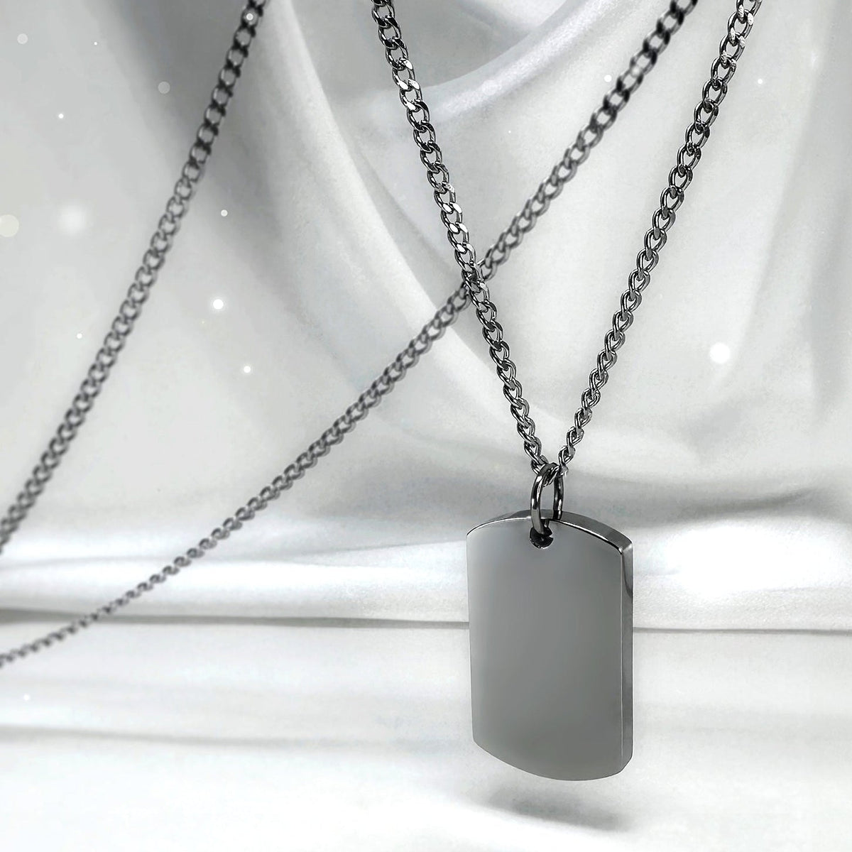 Blank polished urn dog tag necklace displayed on a satin background, ready for custom engraving