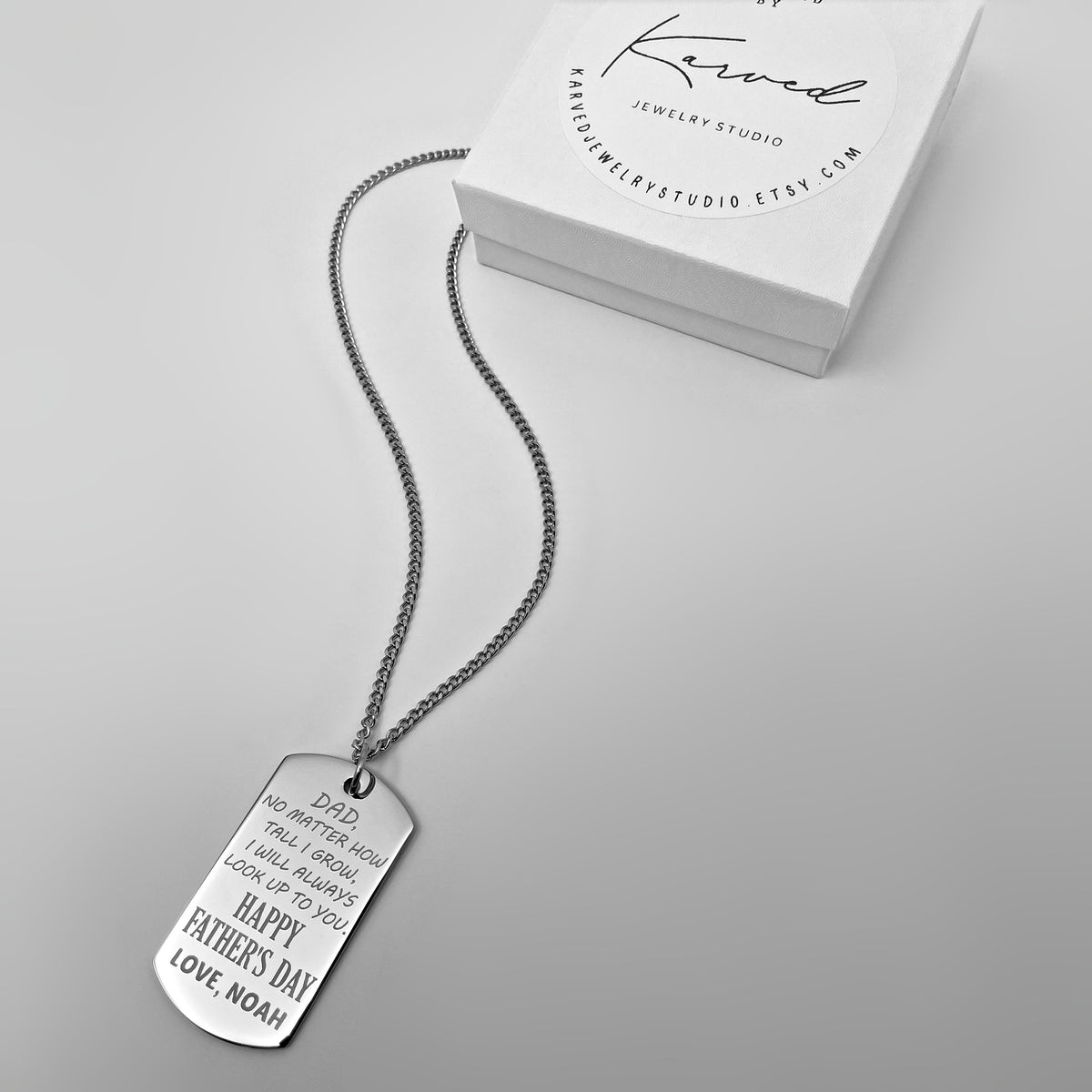 Personalized Father’s Day photo dog tag necklace displayed beside a gift box