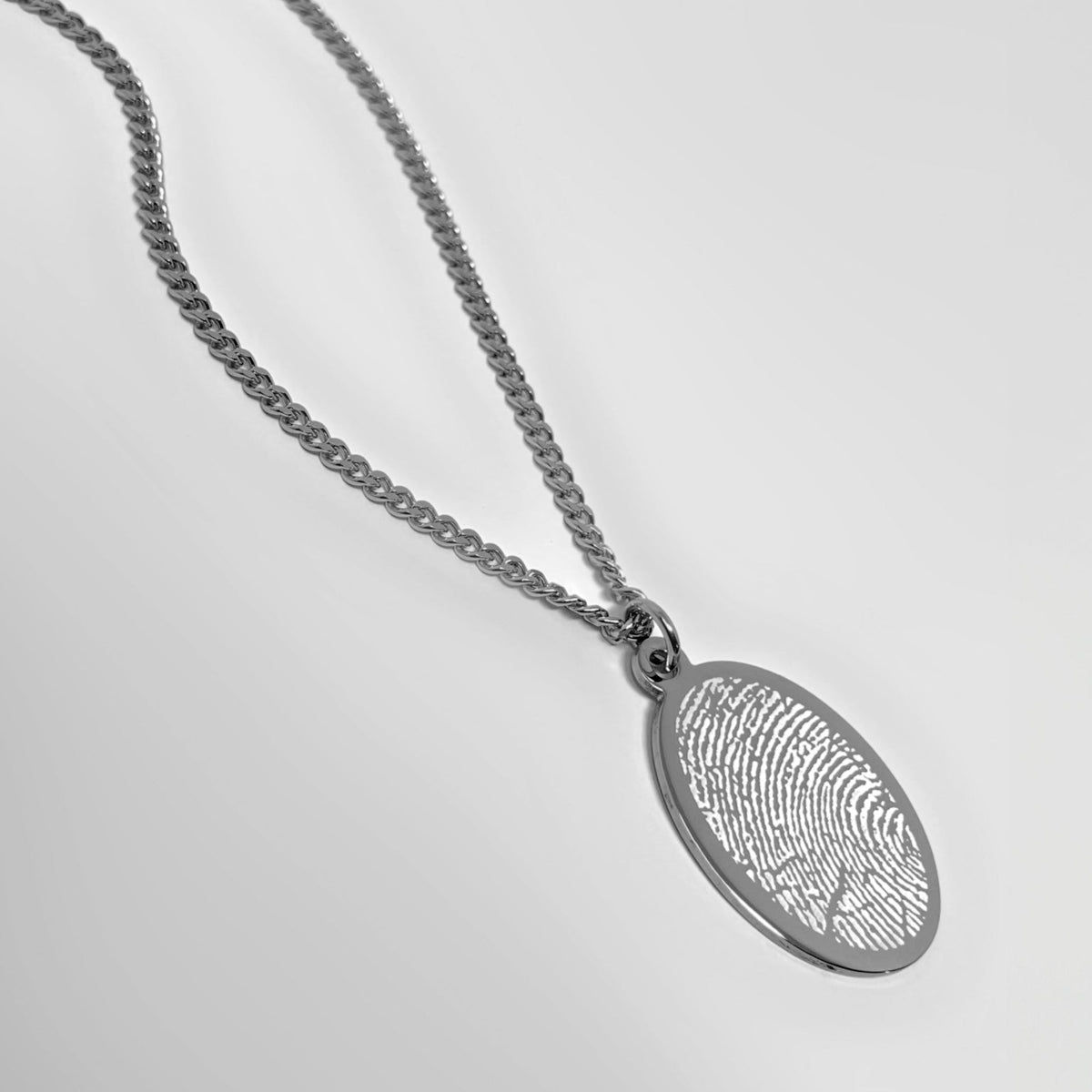 Custom fingerprint oval necklace with an actual fingerprint engraving on polished stainless steel