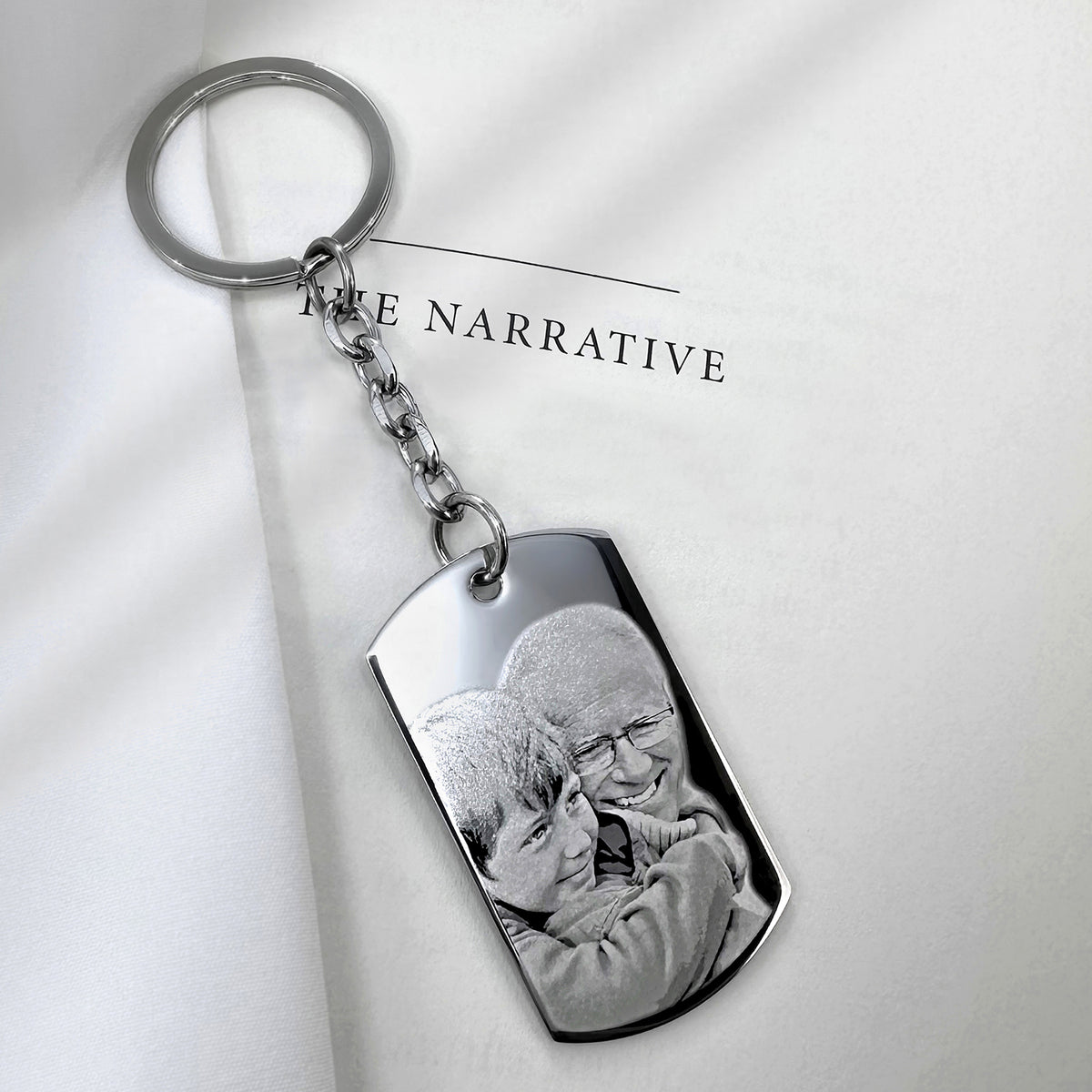 Custom Grandpa photo memorial dog tag keychain with round keyring and engraved portrait displayed in a soft lifestyle setting