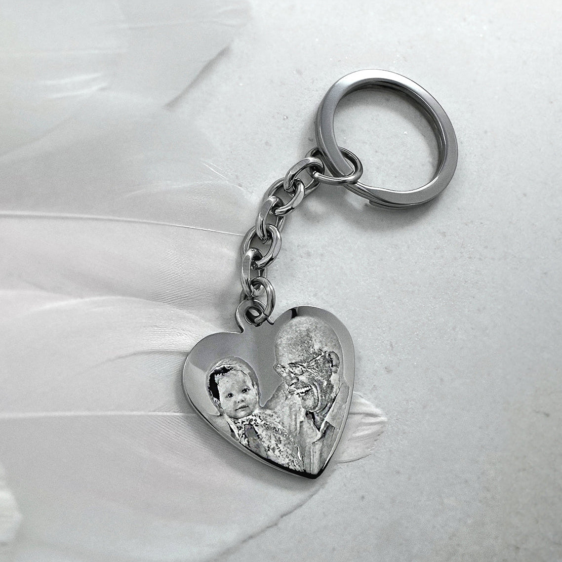 Custom Grandpa memorial heart keychain with custom portrait photo engraving displayed on soft fabric