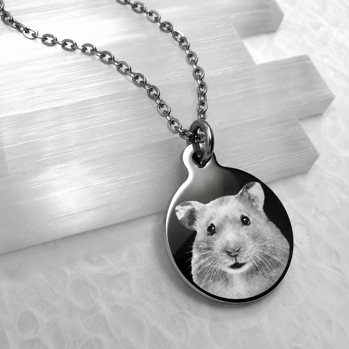 Personalized silver round pet portrait necklace featuring a hamster photo engraved on a polished stainless-steel pendant.