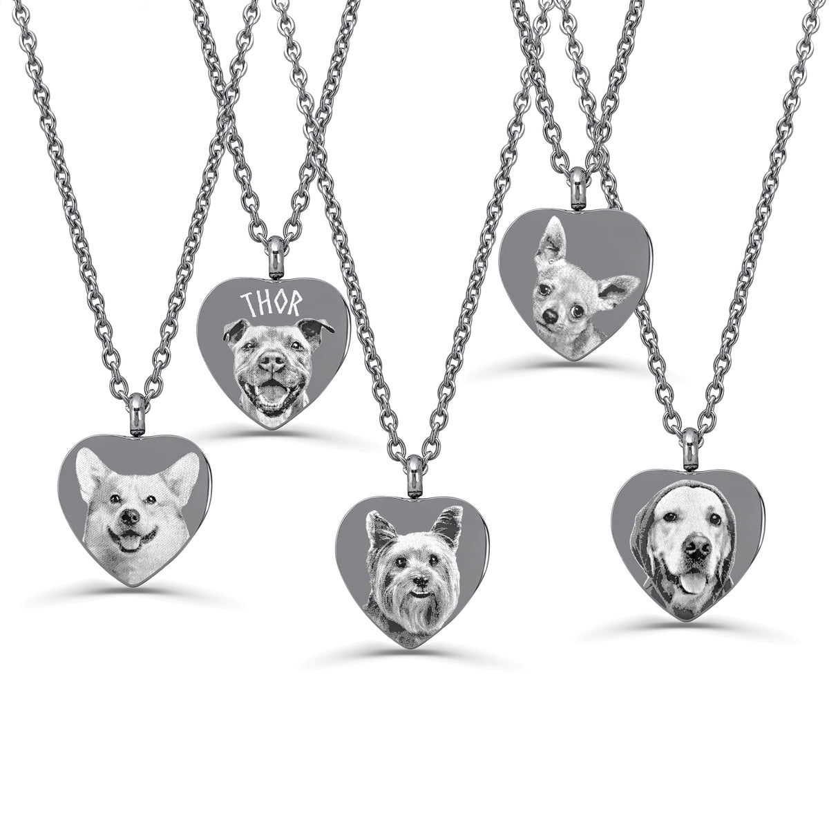 Five heart-shaped urn pendant necklaces on stainless steel chains, each engraved with a different dog portrait or name, shown on a clean white background.