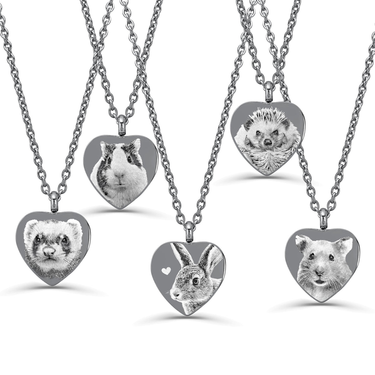 Five heart-shaped urn pendant necklaces on silver chains, each featuring a different animal portrait engraving including a ferret, guinea pig, hedgehog, rabbit, and hamster, displayed on a clean white background.