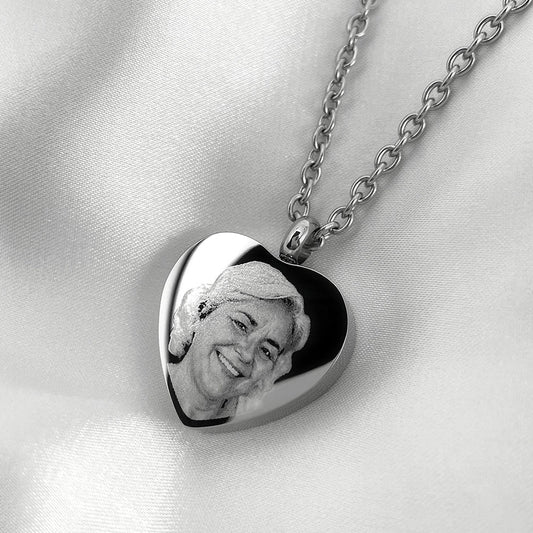 Personalized heart urn necklace with engraved woman’s portrait displayed with silver chain