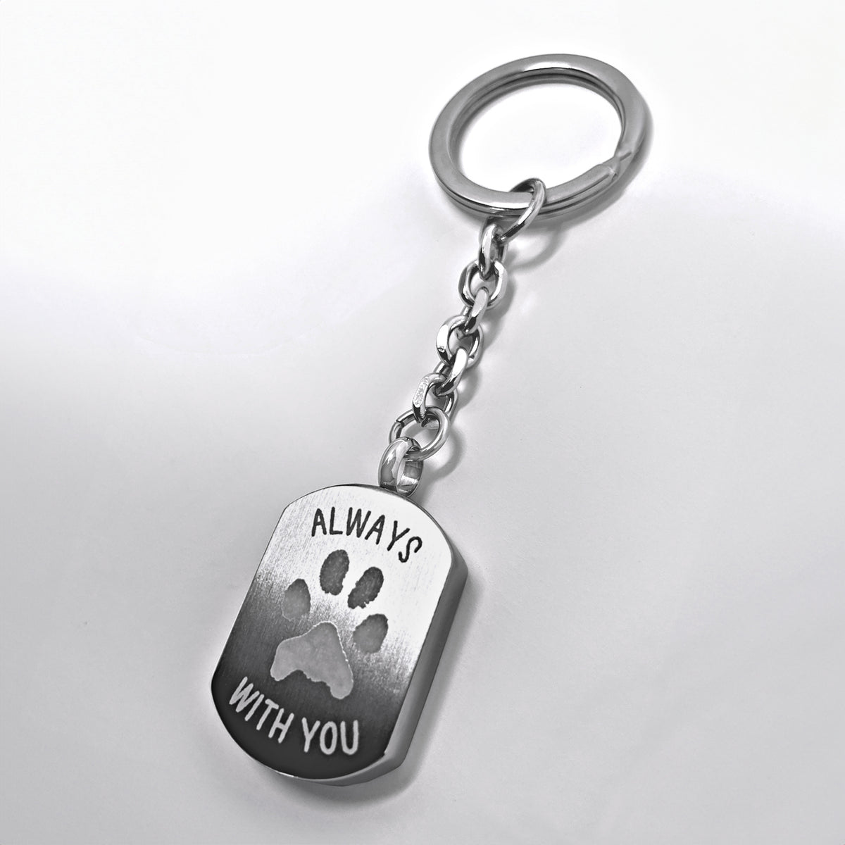 Personalized dog tag urn keychain engraved with “Always with you” and a custom paw print design