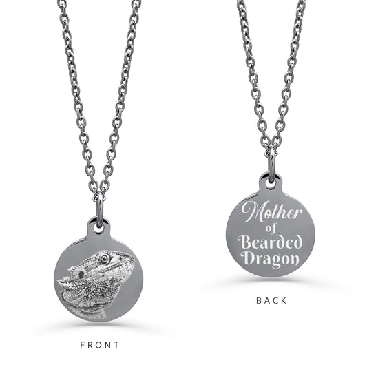 A silver round personalized pendant necklace on a white background. The left 'FRONT' view shows an engraved custom bearded dragon portrait, and the right 'BACK' view shows personalized text 'Mother of Bearded Dragon'.