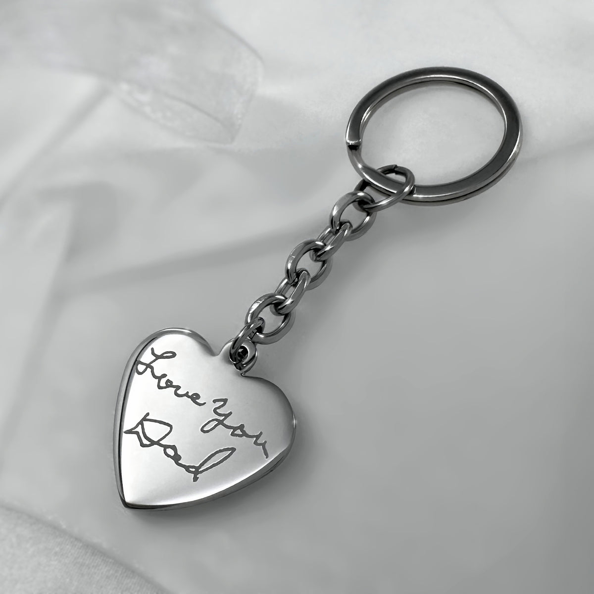 Personalized silver heart-shaped keychain engraved with custom handwriting “Love You Dad” message