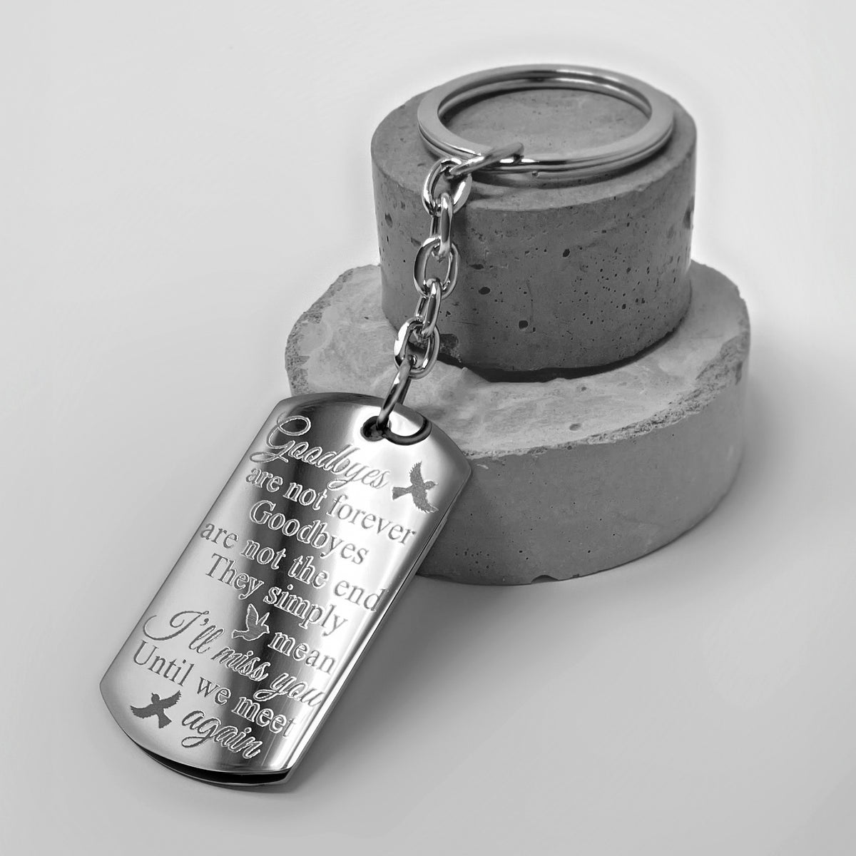 Sister memorial dog tag keychain close-up showing engraved “Goodbyes are not forever” remembrance quote