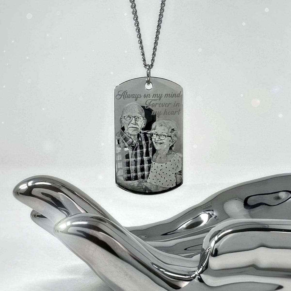 Custom loved one couple photo memorial dog tag necklace displayed on a sculptural silver stand