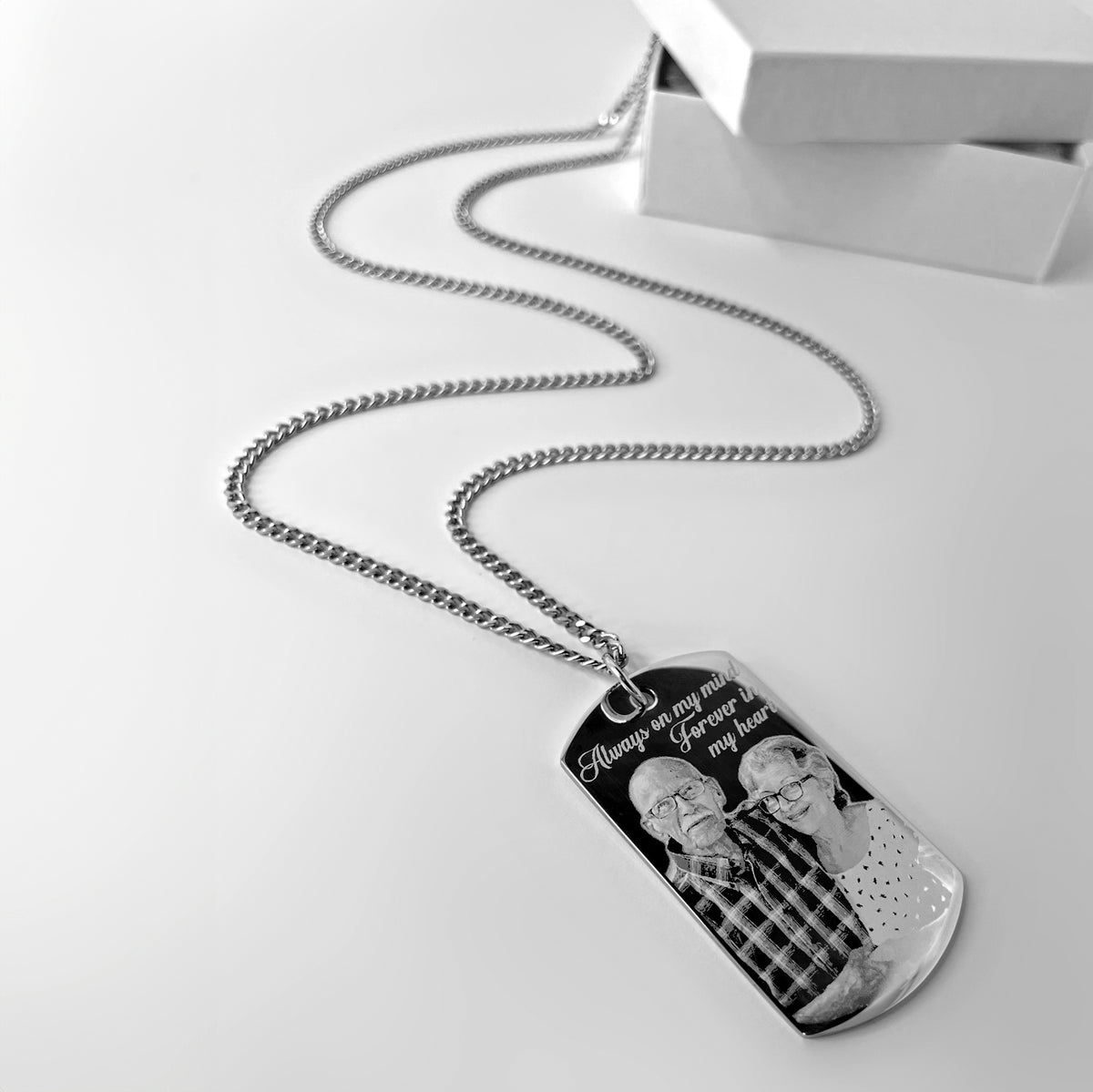 Personalized memorial photo dog tag necklace shown in a styled gift display