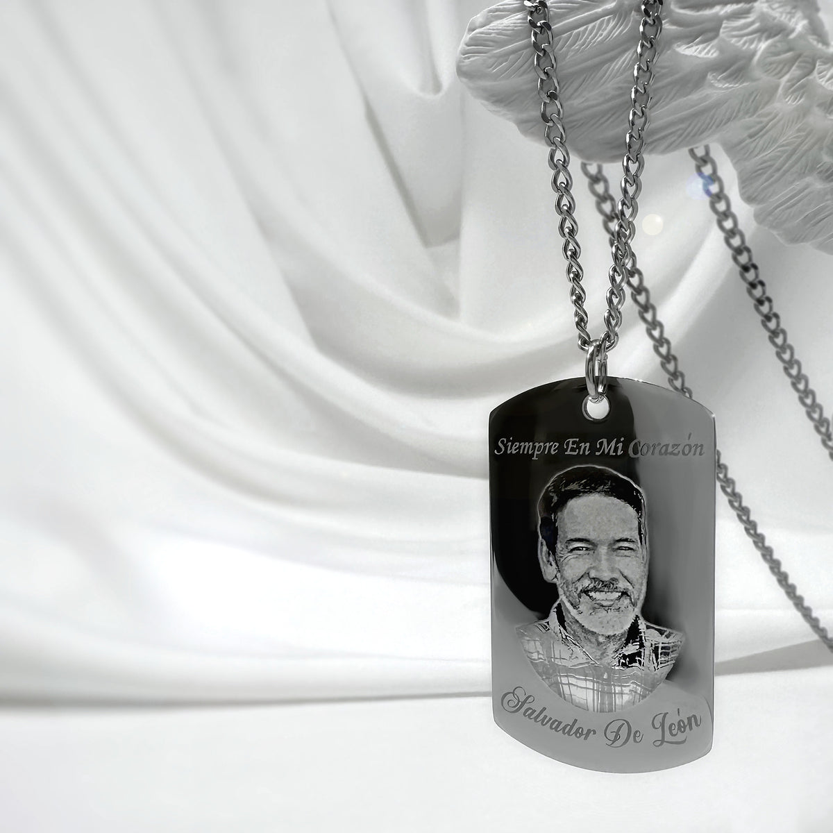 Personalized memorial photo fingerprint dog tag necklace displayed on satin