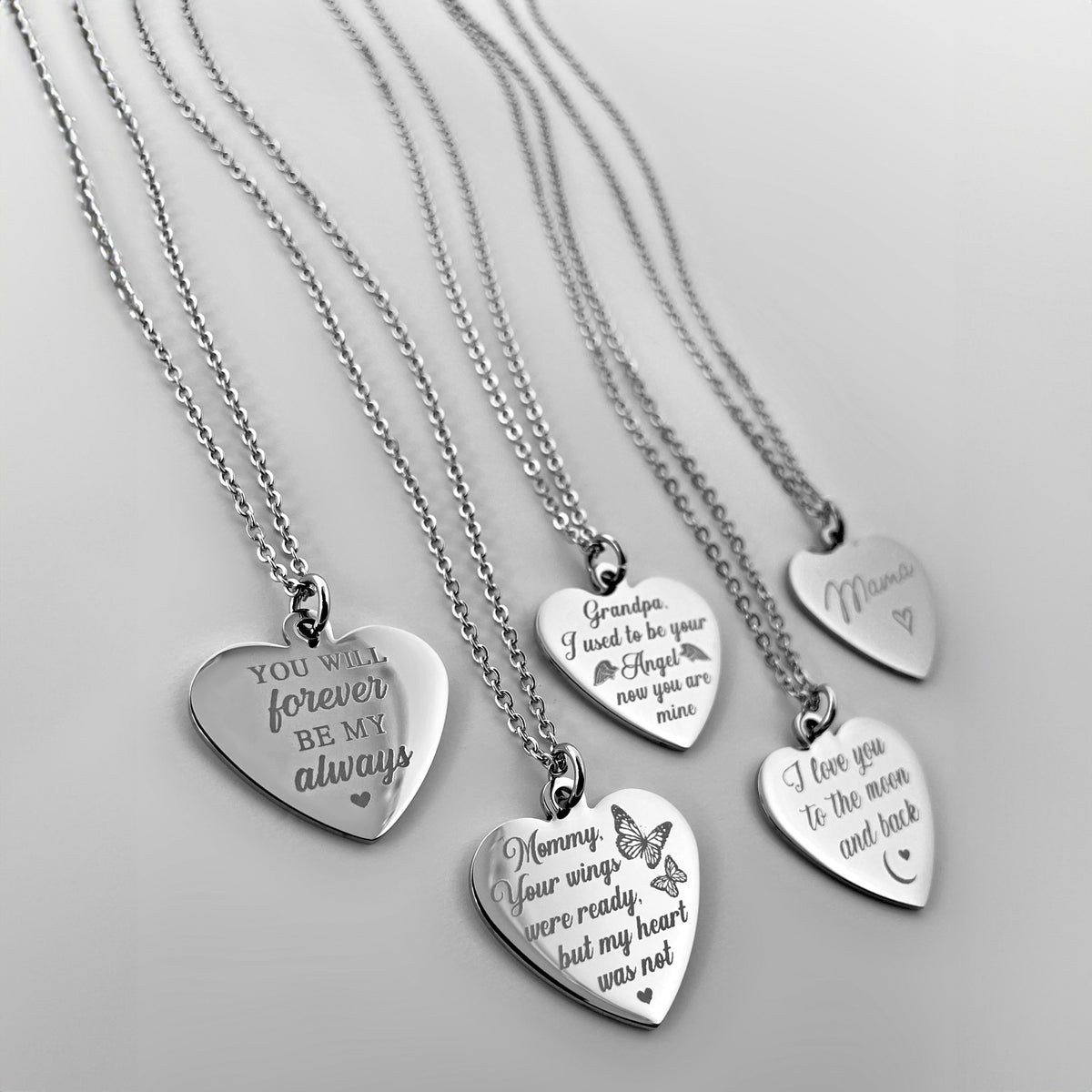 Five silver heart-shaped pendant necklaces with engraved memorial messages