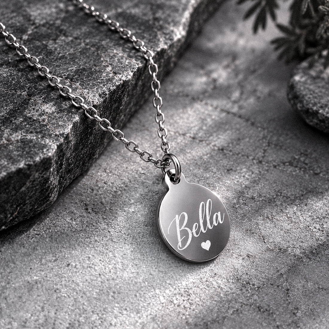Personalized round pendant necklace engraved with the name Bella and a small heart