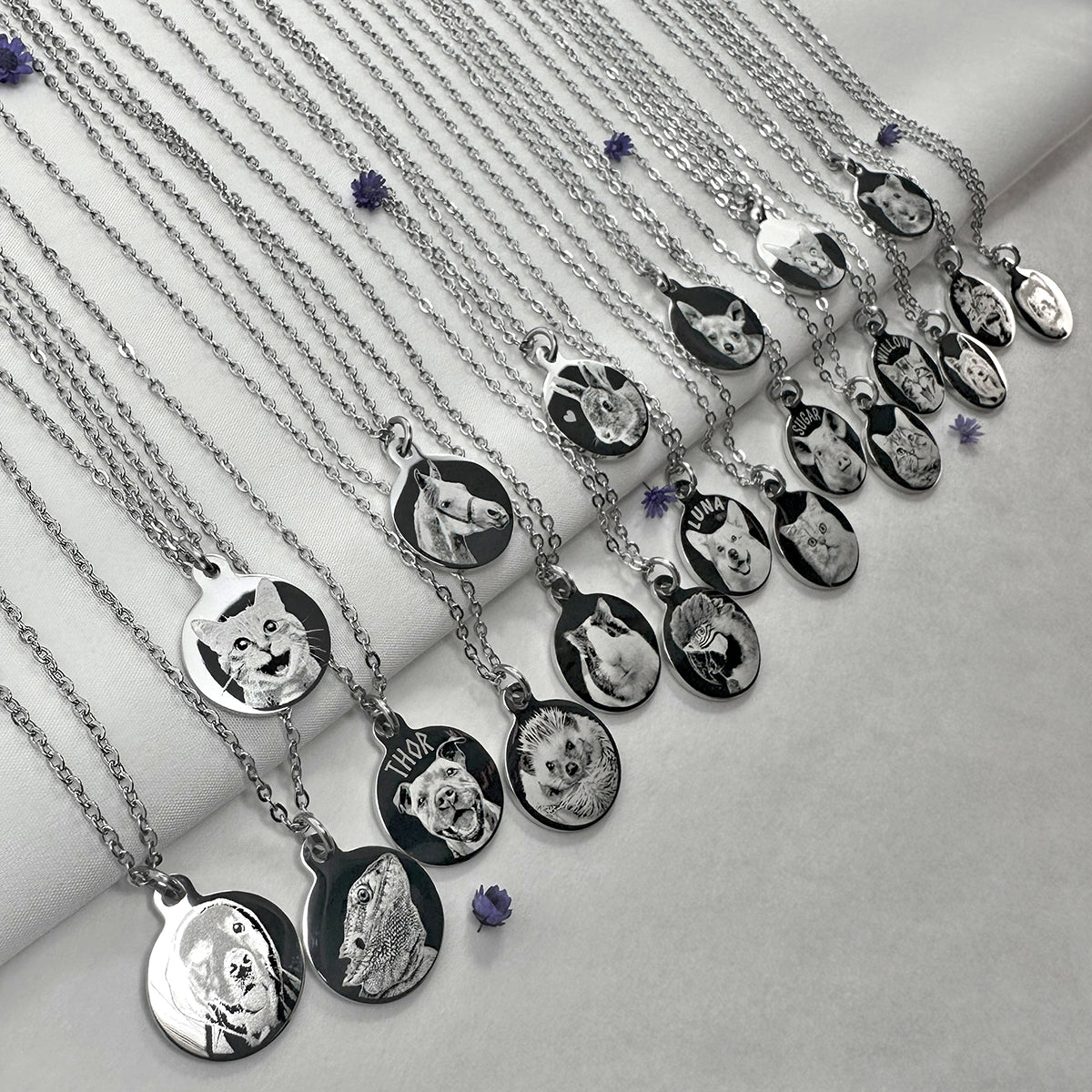 A set of silver round pendant necklaces with custom engraved various pet portraits.