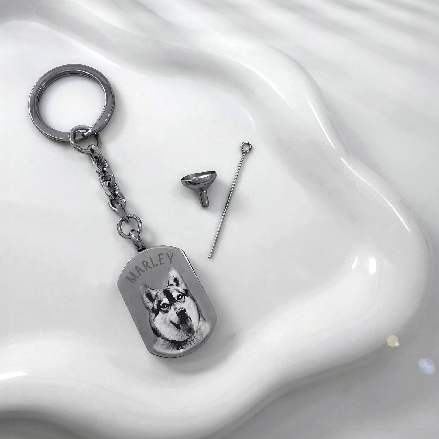 Personalized pet photo urn keychain displayed with the included funnel and filling pin.
