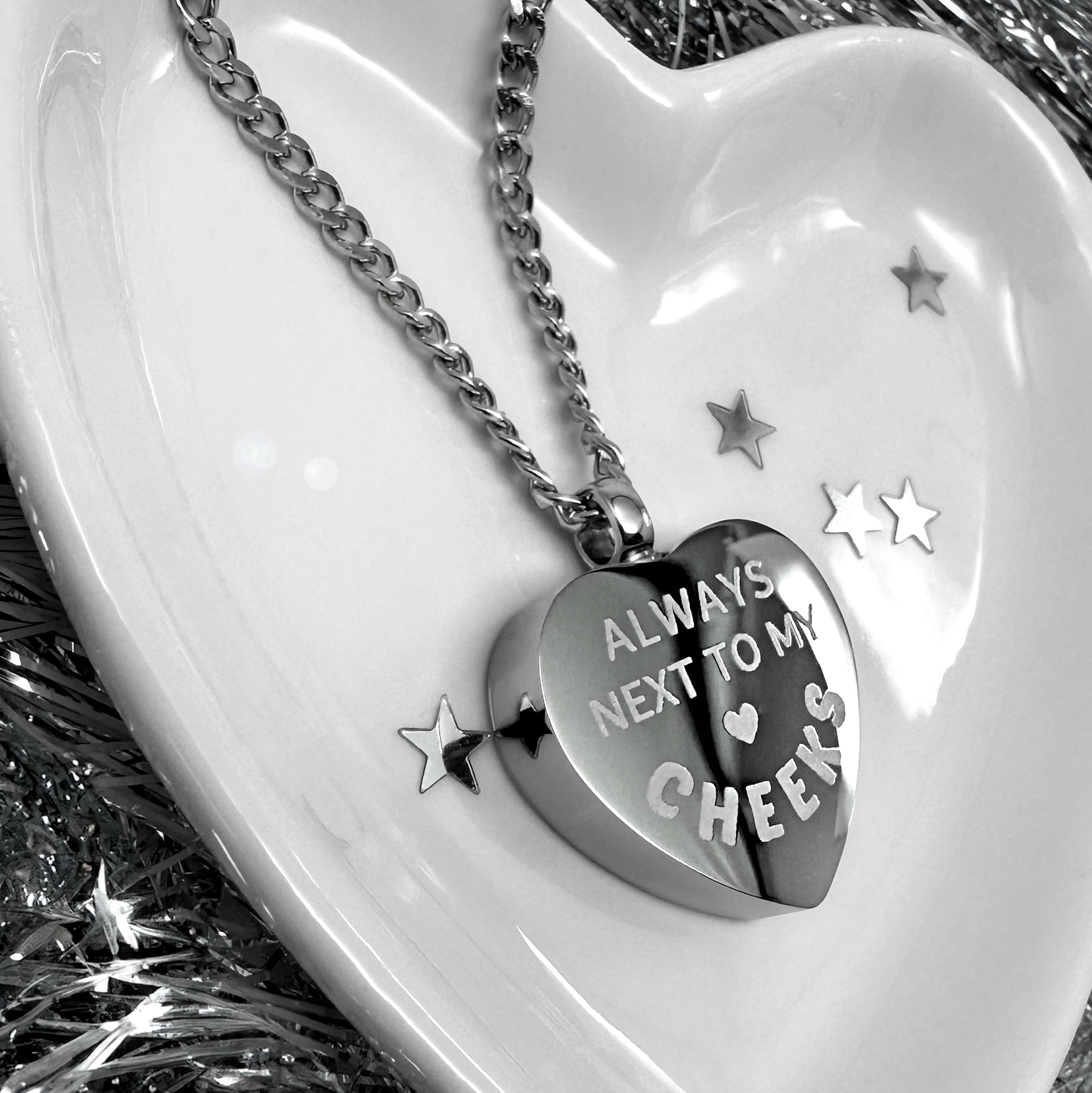Back of a personalized hamster cremation urn necklace with custom memorial text engraving.