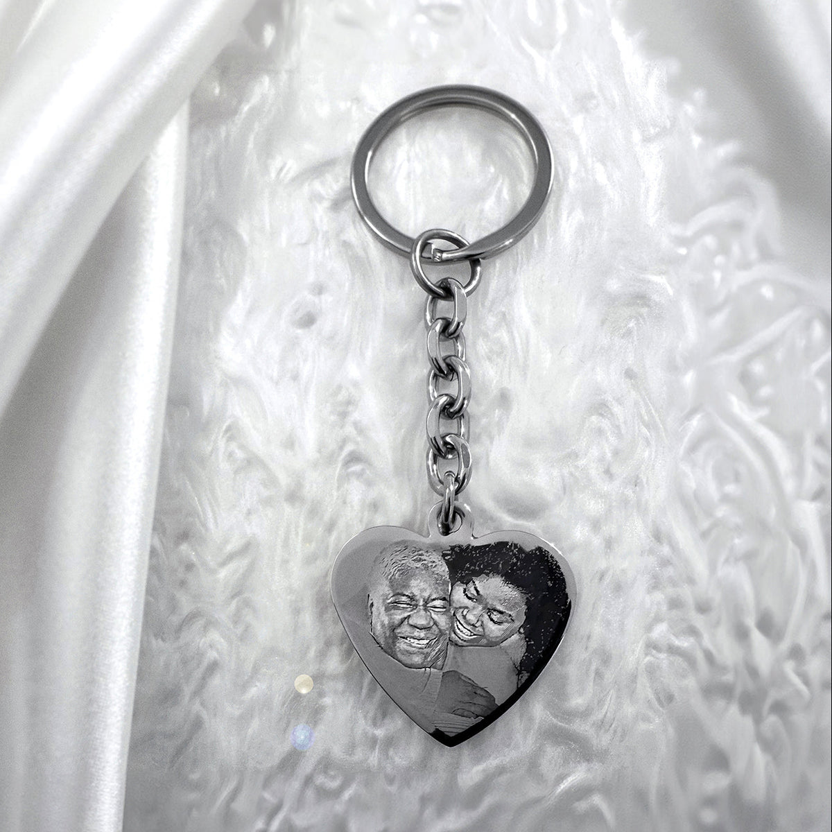Personalized photo memorial silver heart keychain displayed on a soft neutral background