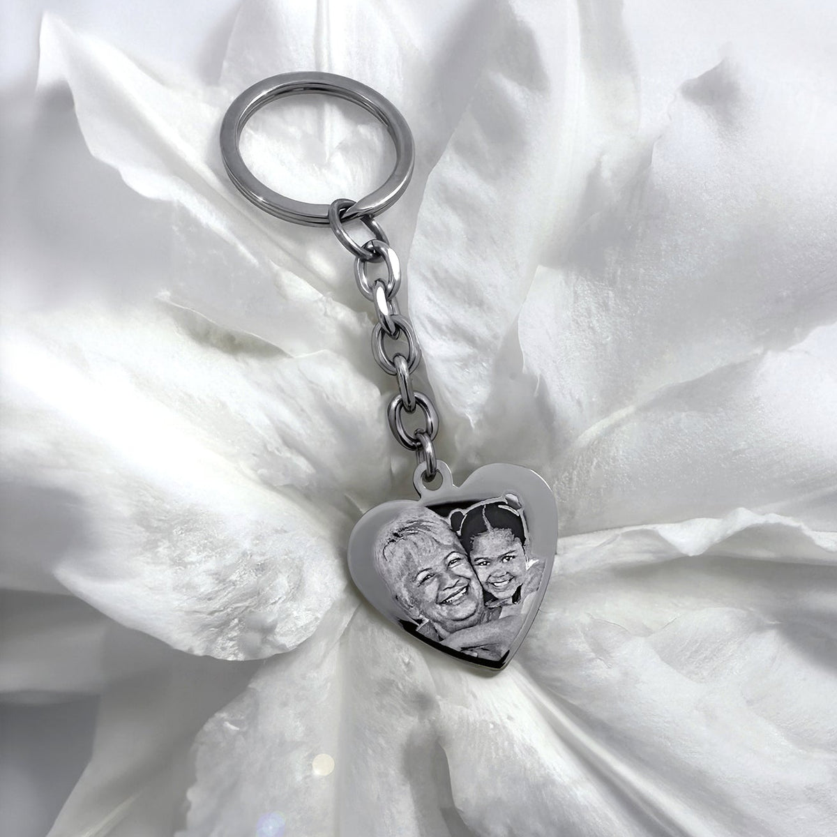 Nana memorial heart keychain with custom portrait photo engraving displayed on soft satin