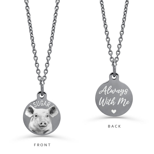 A silver round pendant necklace on a white background. The left 'FRONT' view shows a custom pig portrait with a personalized name above it.