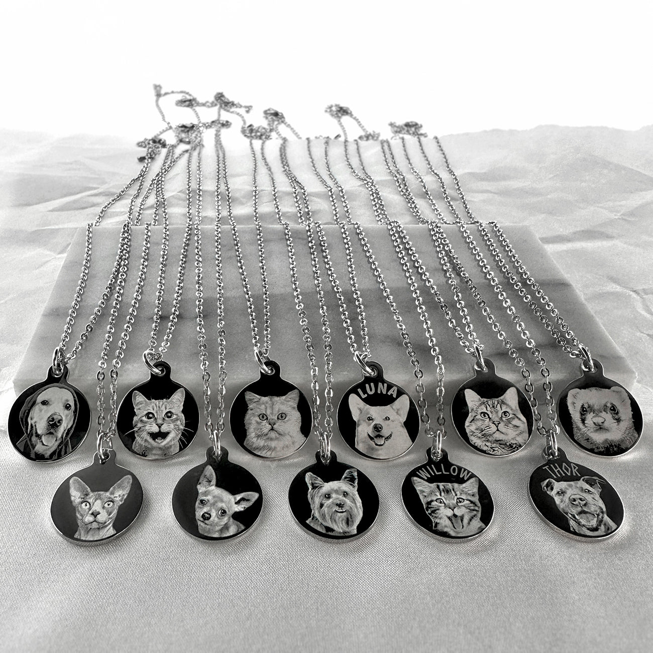 Video showing personalized round pet portrait necklaces engraved with different animals