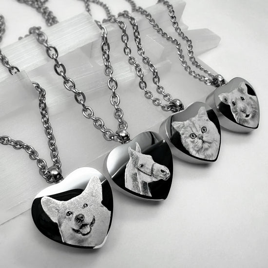 Video showing personalized heart-shaped pet cremation urn necklaces with custom portraits, names, paw prints, nose prints, and memorial engraving variations.