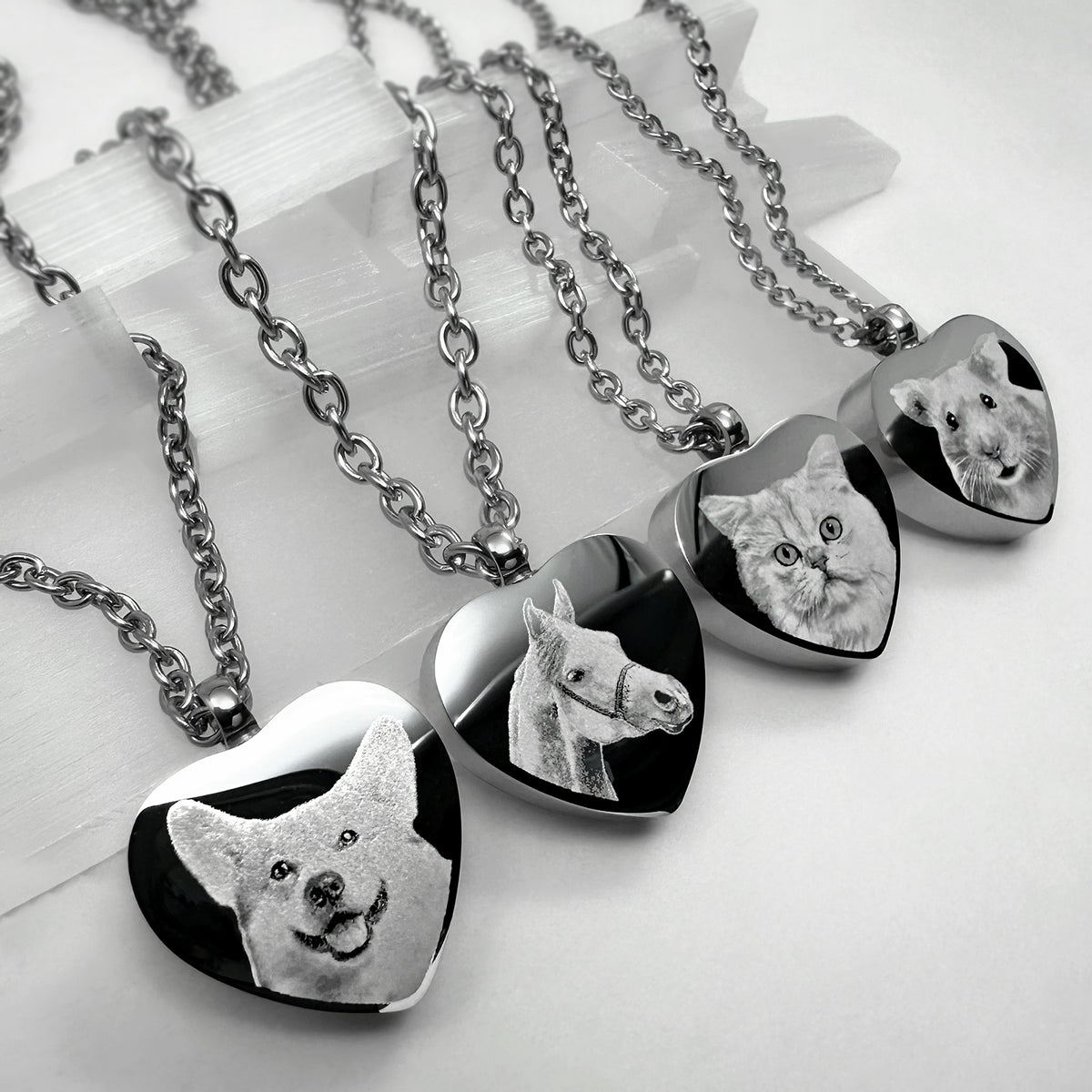 Video showing personalized heart-shaped pet cremation urn necklaces with custom portraits, names, paw prints, nose prints, and memorial engraving variations.