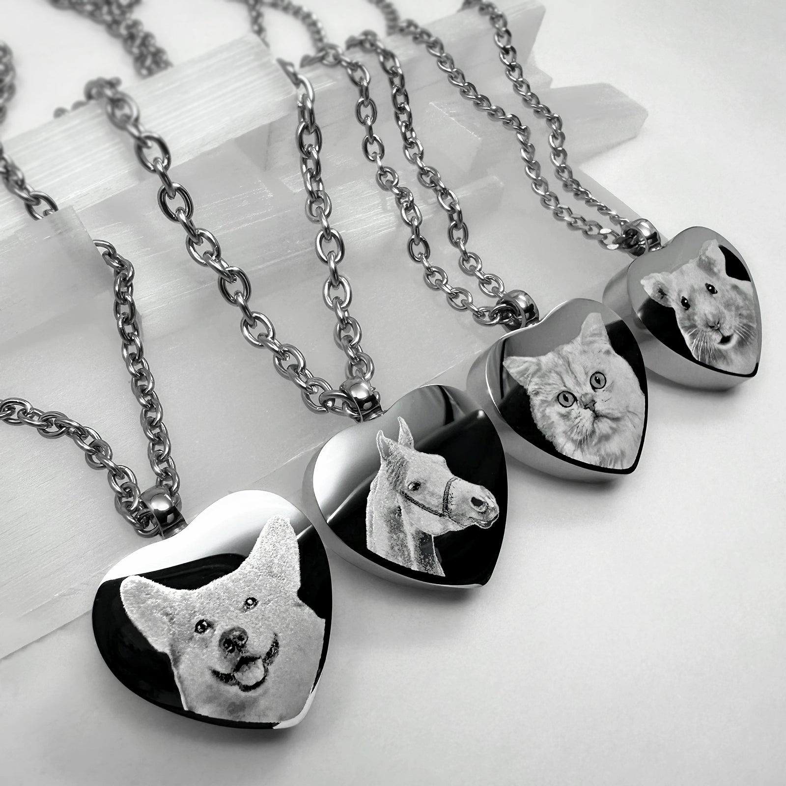Video showing personalized heart-shaped pet cremation urn necklaces with custom portraits, names, paw prints, nose prints, and memorial engraving variations.