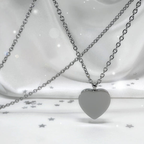 Custom heart urn necklace shown front and back with engraved portrait and fingerprint