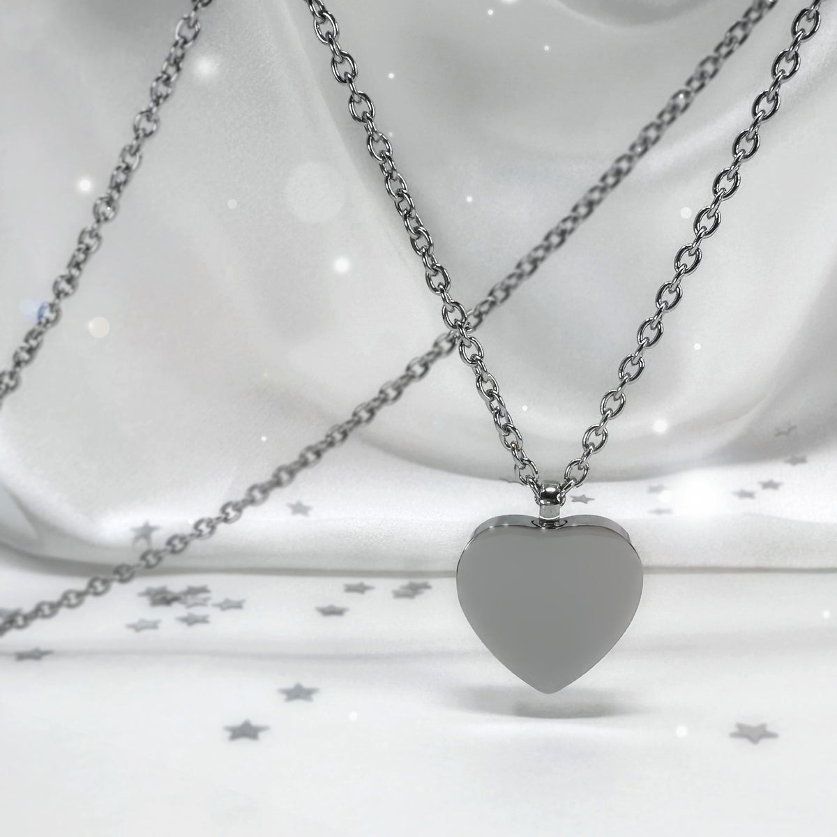 Custom heart urn necklace shown front and back with engraved portrait and fingerprint