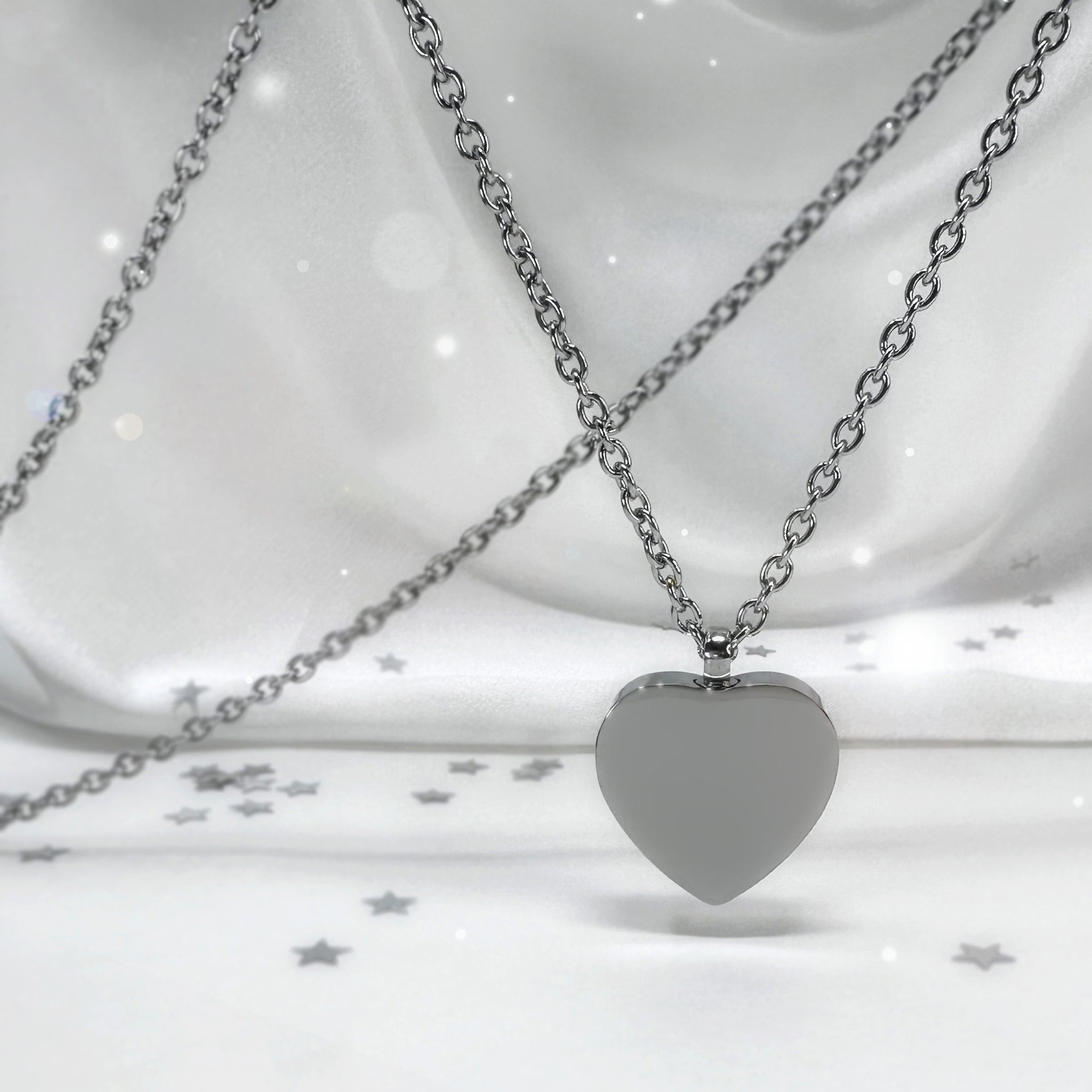 Custom heart urn necklace shown front and back with engraved portrait and fingerprint