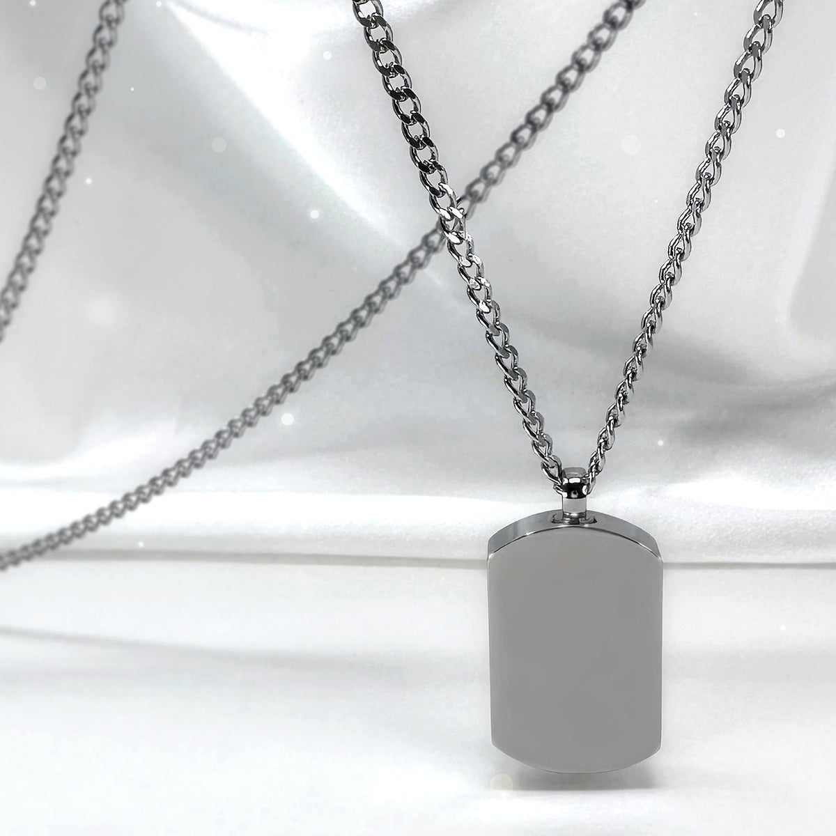 Blank polished stainless steel small dog tag urn necklaces displayed on marble, ready for custom photo, fingerprint, handwriting, or message engraving